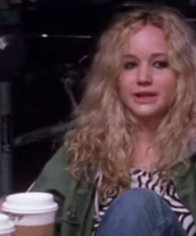 A person sitting at a table with a coffee cup
Description automatically generated